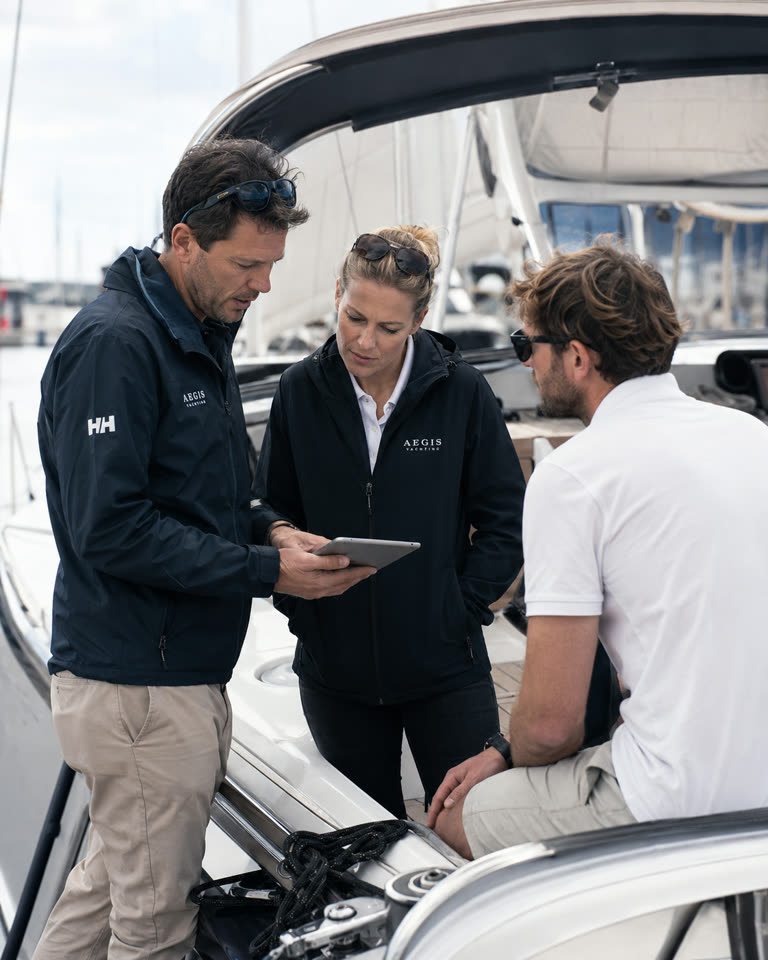 Yacht charter professionals reviewing a charter workflow together.